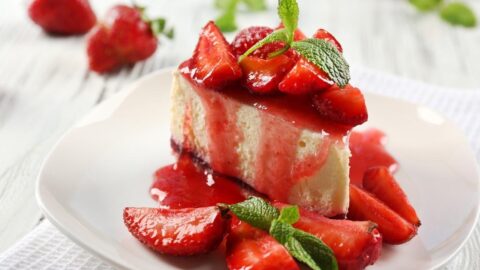 Slice of Sweet Homemade Strawberry Cheesecake with Sauce