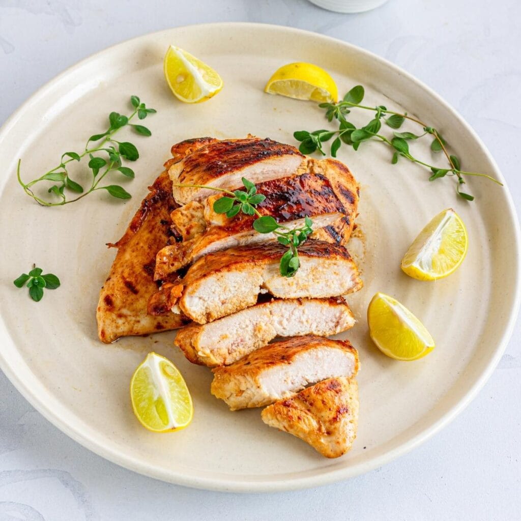 Sliced Grilled Chicken with Lemon on a plate