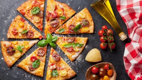 Sliced Homemade Pizza with Mozzarella, Tomatoes and Basil