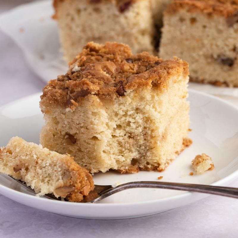 Fluffy Sour Cream Coffee Cake Served on a Small White Platter