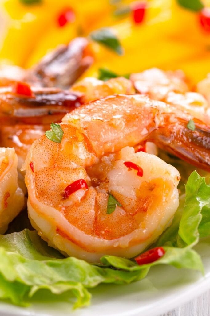 Spicy prawns with mango salad and vegetables