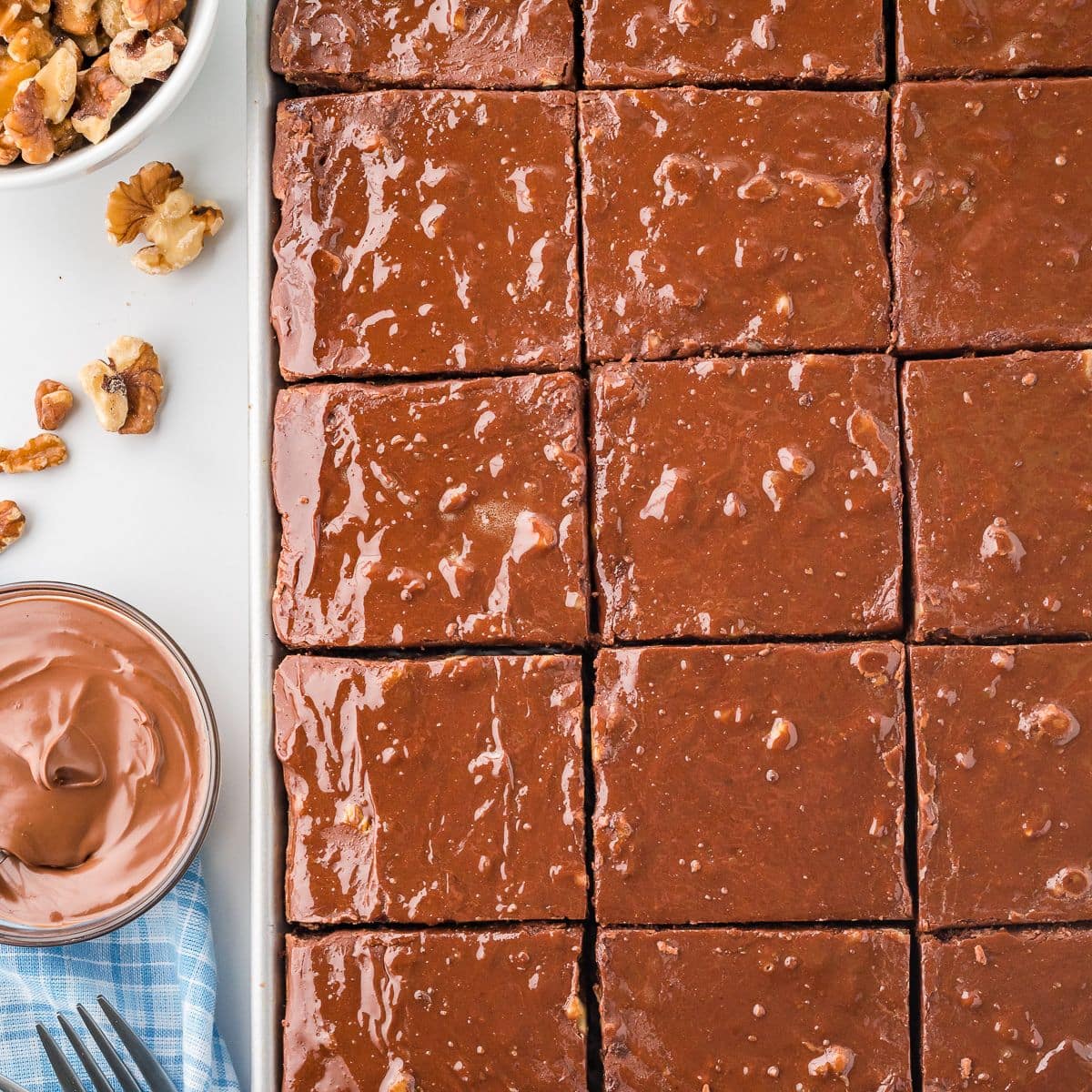 Overhead shot of a sliced Texas sheet cake in a pan.