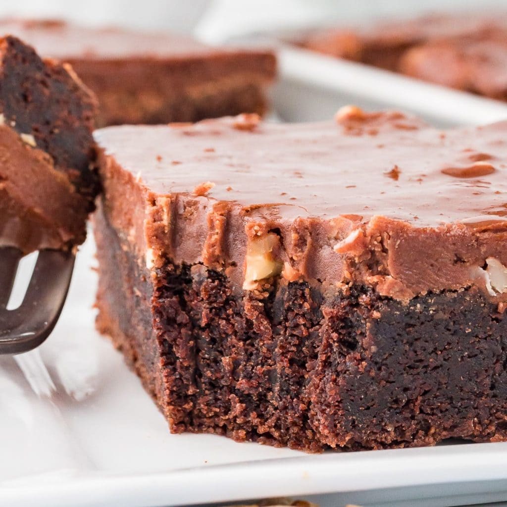 A slice of Texas sheet cake served in a white plate.