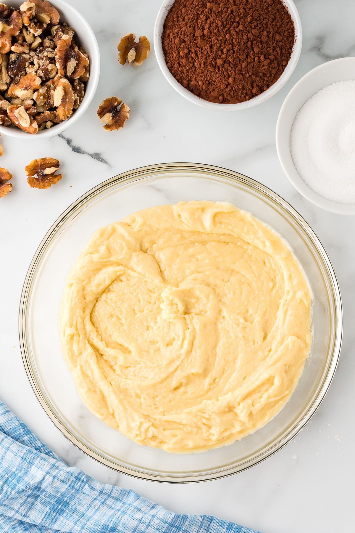 Sheet cake batter in a glass mixing bowl.