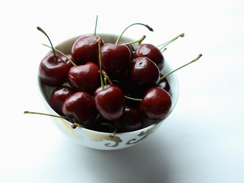 Tieton Cherries on a Small Ceramic Bowl