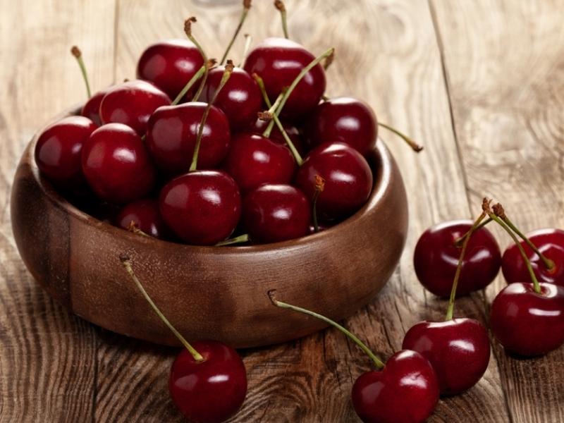 Bloody Red Fresh Cherries on a Wooden Basket Bowl