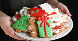 Woman Holding a Plate with Delicious Christmas Gingerbread Cookies