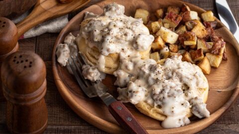 Biscuits and Ground Beef with Gravy and Potatoes in a Wooden Plate