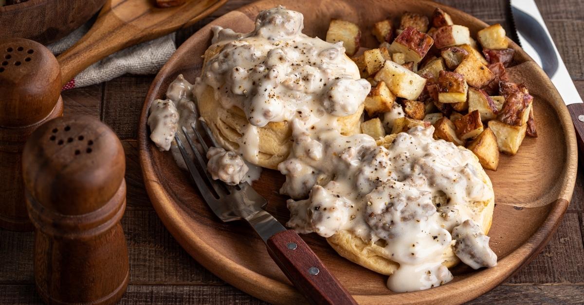 Biscuits and Ground Beef with Gravy and Potatoes in a Wooden Plate