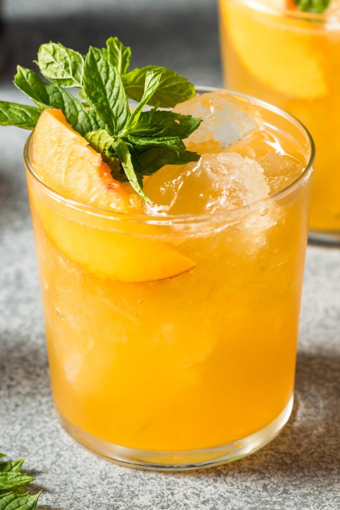 Boozy Refreshing Peach Smash Cocktail with Vodka and Mint