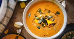 Bowl of Homemade Carnival Squash Soup with Pumpkin Seeds