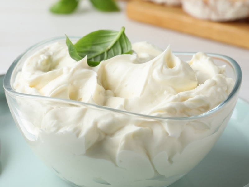 Creamy Cream Cheese on a Glass Bowl With Basil Leaf on Top
