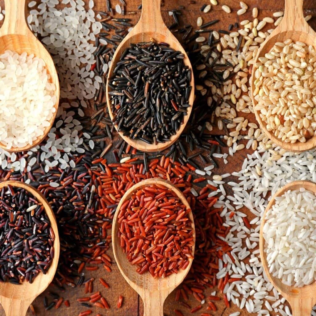 Different Types of Rice in a Wooden Spoon