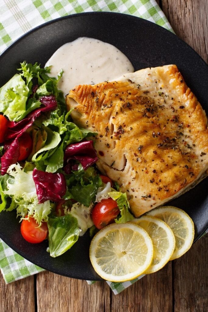 Grilled Arctic Char Fillet with Mixed Salad and Lemons