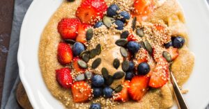 Healthy Homemade Amaranth Porridge with Berries, Peanut Butter and Pumpkin Seeds