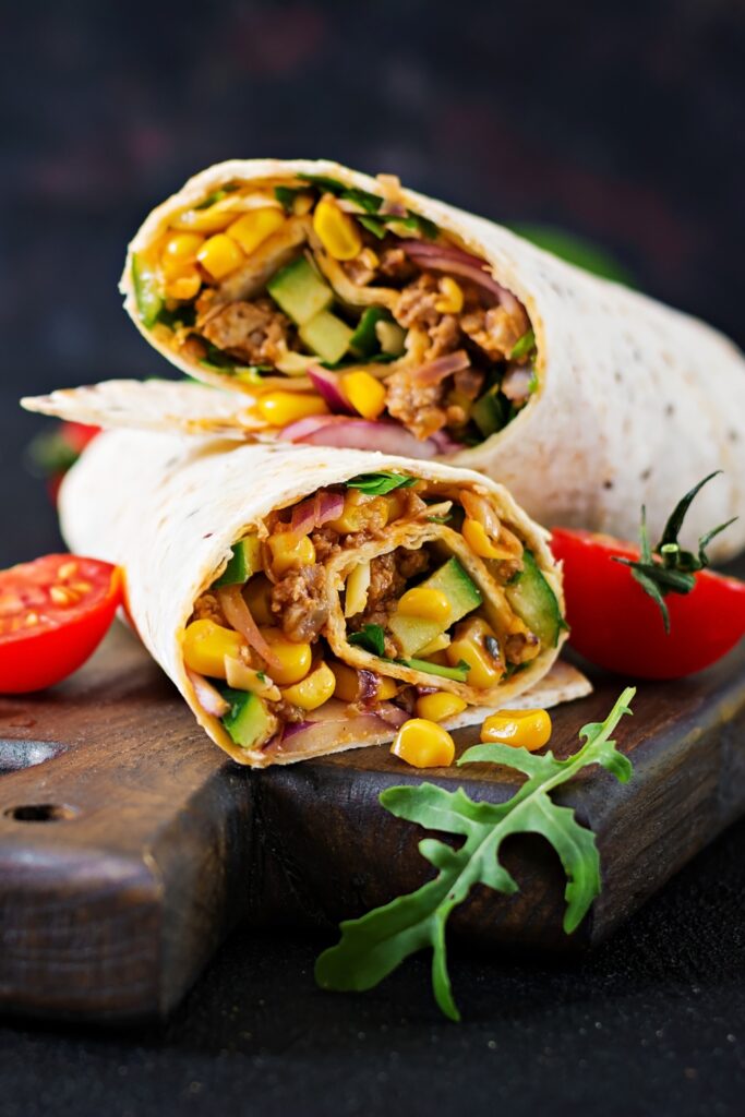Homemade burrito wraps with beef, vegetables and corn