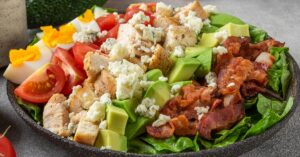 Homemade Cobb Salad with Chicken, Eggs, Tomatoes, Avocados and Bacon