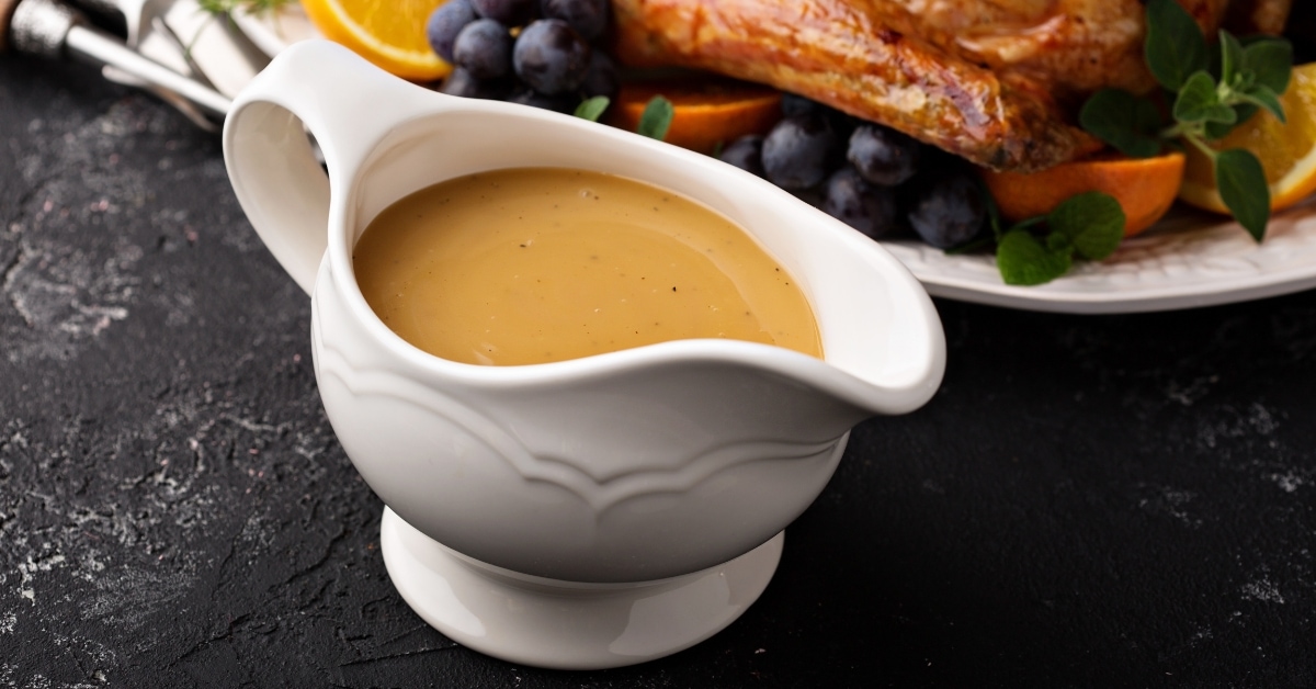 Homemade Gravy in a Bowl with Roasted Turkey