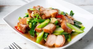 Homemade Grilled Pork Belly with Stir-Fried Vegetables in a White Plate