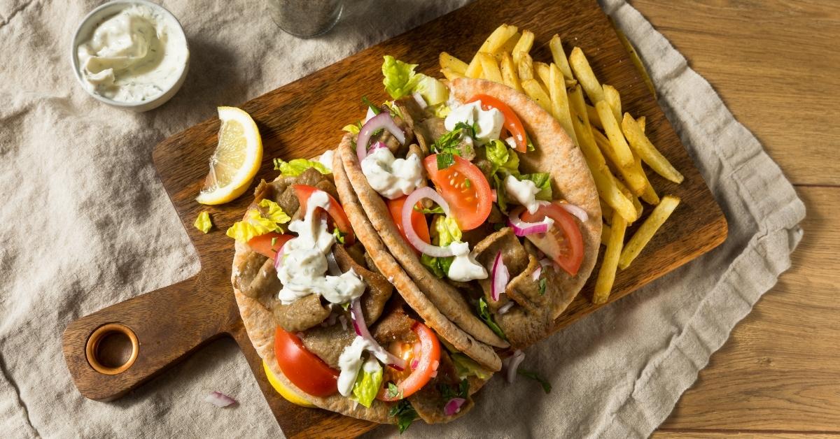 Homemade Gyros Sandwich with Tatziki, Fries, Tomatoes and Lettuce