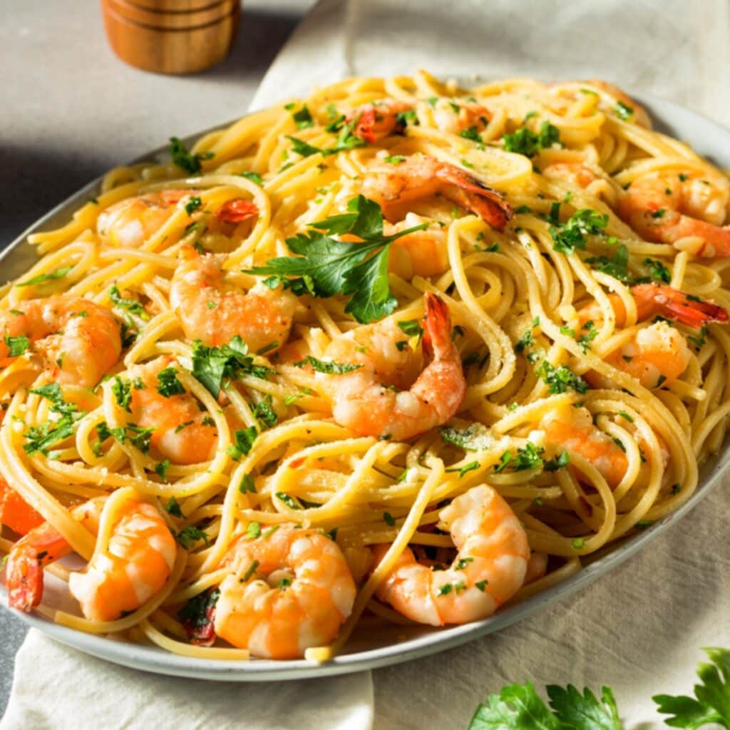 Ina Garten Shrimp Scampi Served on a Stainless Dish
