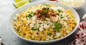 Mexican Corn Elote with Cheese and Paprika in a White Plate