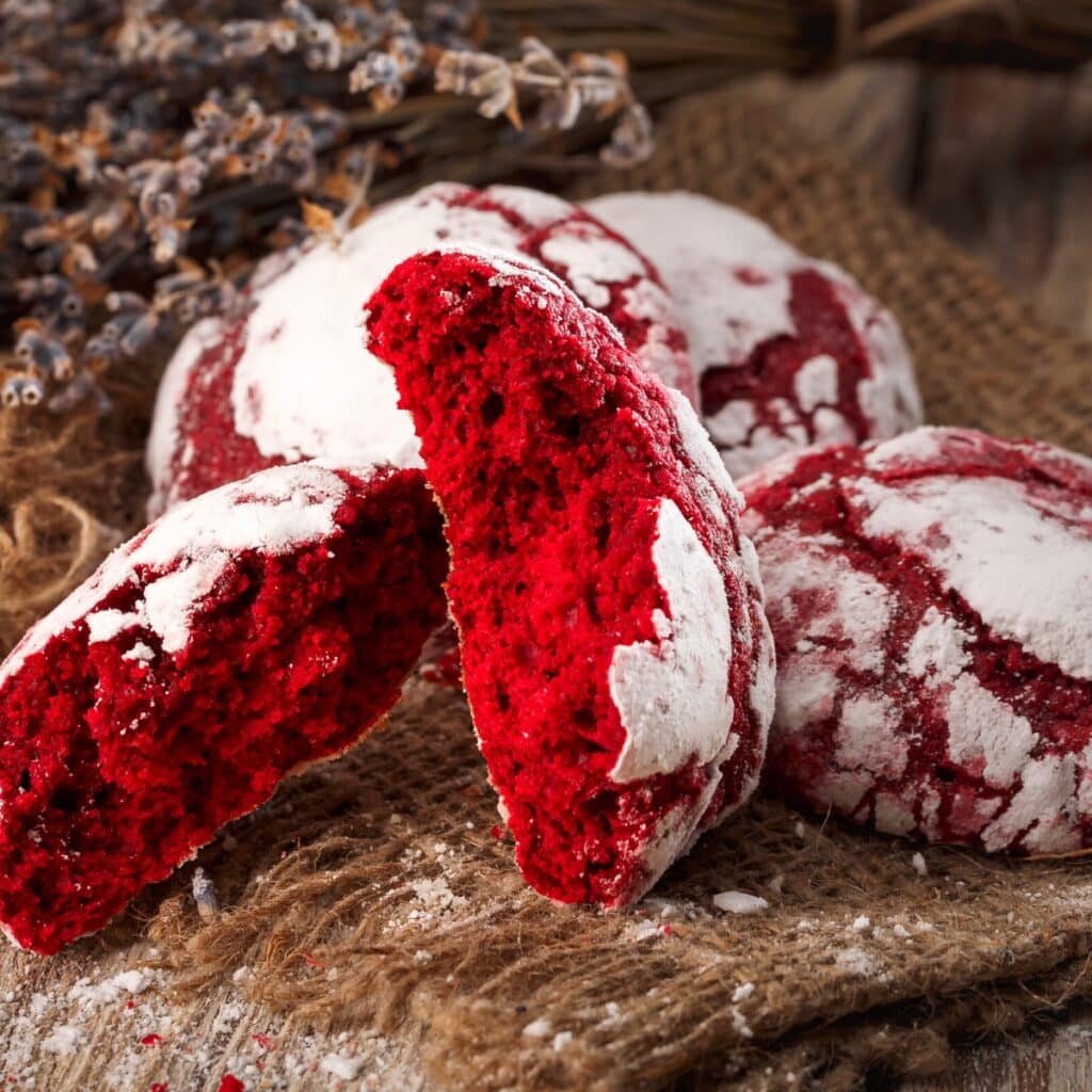 Red Velvet Crinkle Cookies Laid on a Rustic Cloth