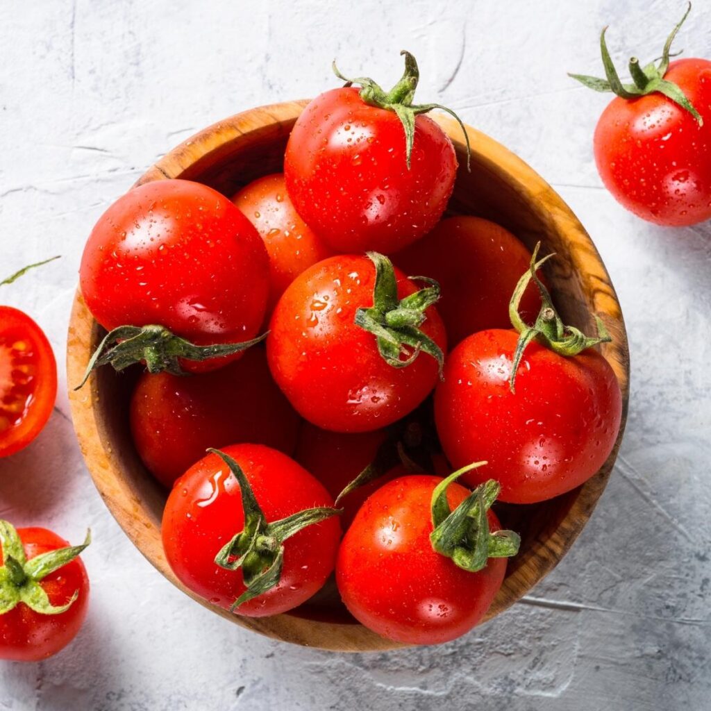 Raw Organic Red Tomatoes in a Wooden Bowl