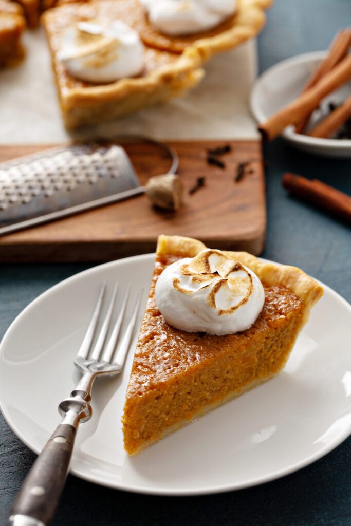 Sliced Of Homemade Sweet Potato Pie with Cinnamon and Whipped Cream