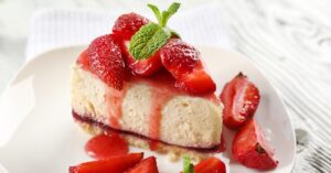 Sliced Homemade Strawberry Cheesecake in a White Plate