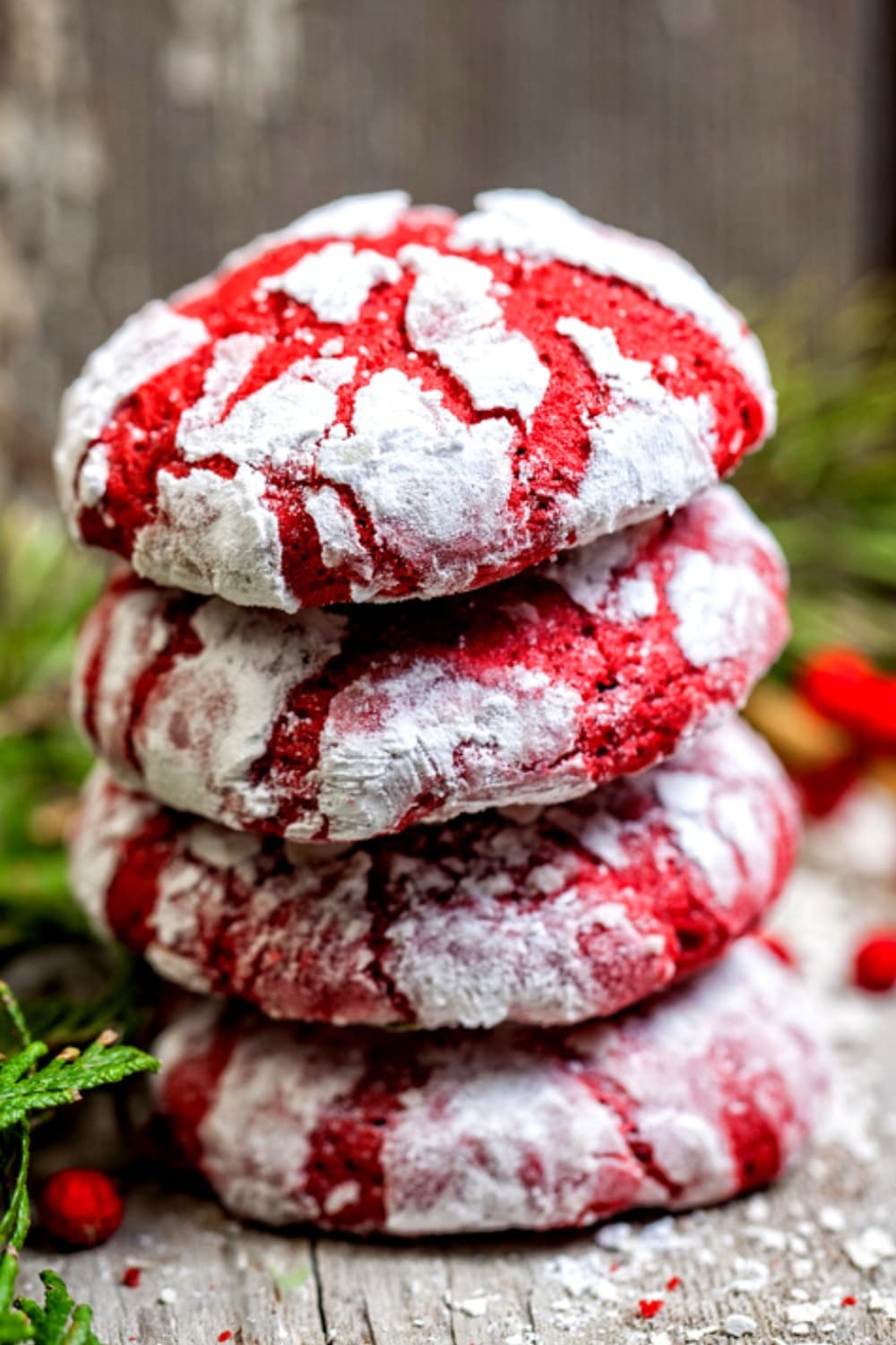 Red Velvet Crinkle Cookies stack on top of each other. 