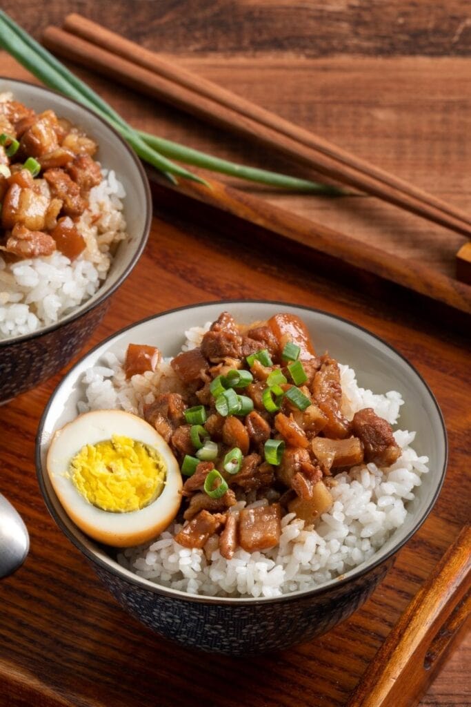 Stewed Pork Over Cooked Rice with Egg and Green Onions