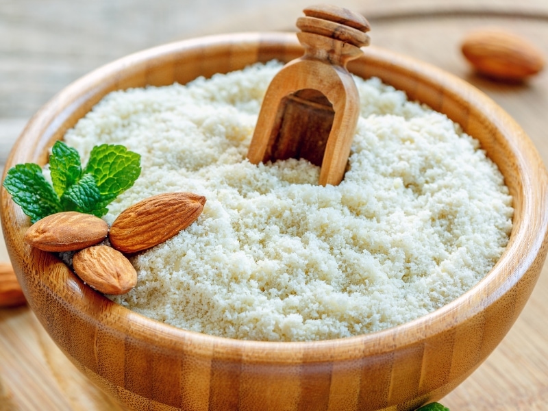 Almond Flour on a Wooden Bowl with Mint and Almonds on Top