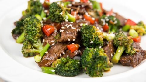 Beef and Broccoli with Sesame Seeds in a White Plate