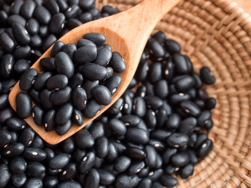 Black Beans on a Basket and Wooden Spoon 