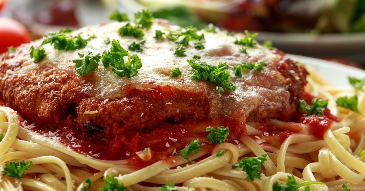 Chicken Parm Served With Pasta on White Plate