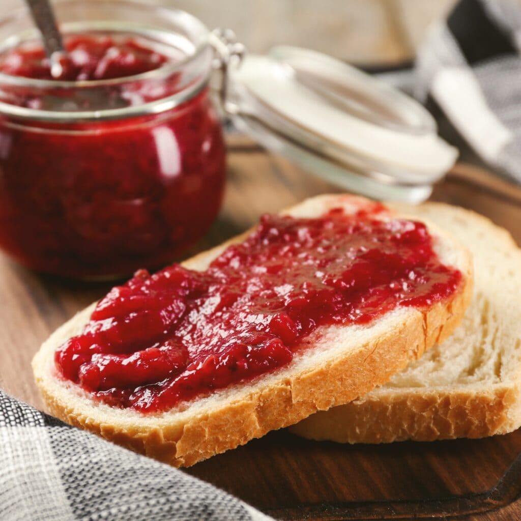 Fruity Bright Red Christmas Jam Spread on Bread Loaf Slice