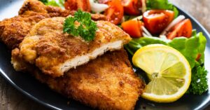 Crispy Oven-Fried Breaded Pork Chop with Tomatoes and Lemon