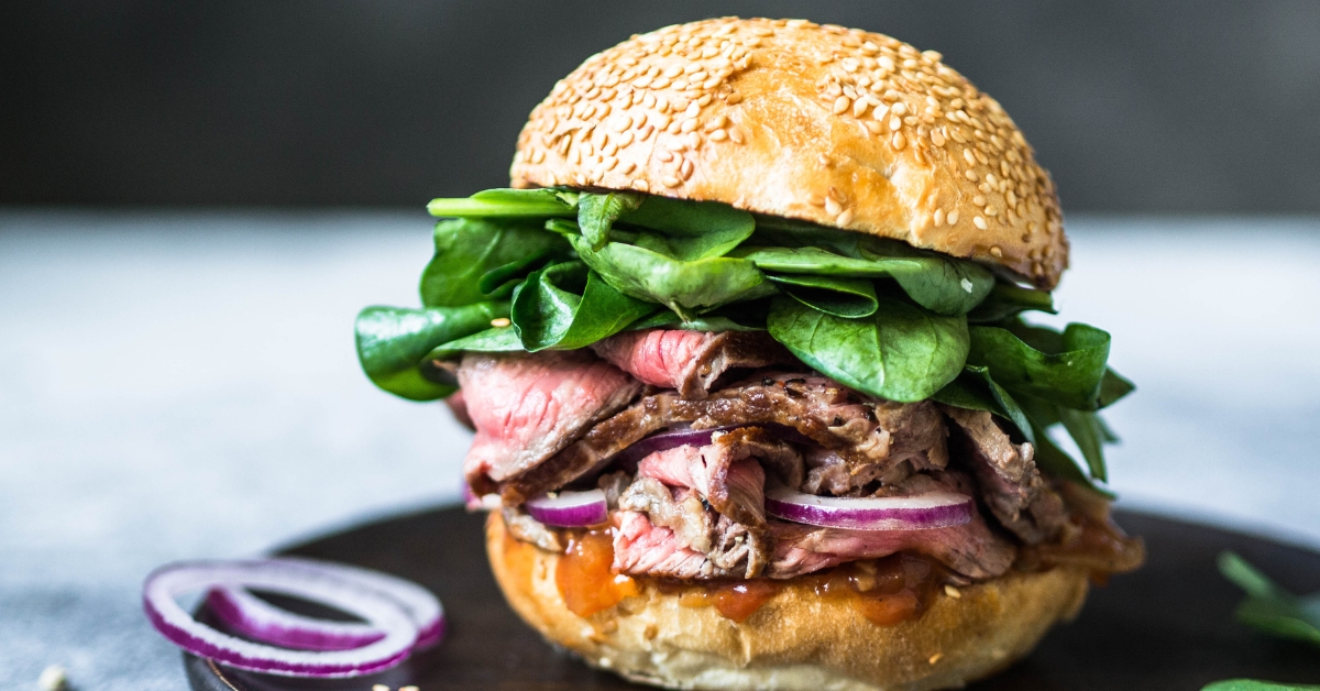 Delicious Homemade Steak Sandwich with Onions and Spinach