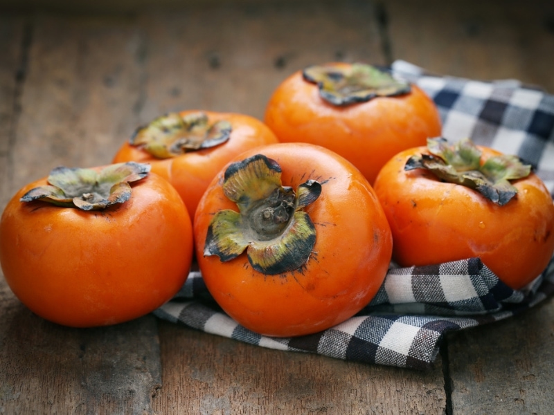 Great Wall Persimmon on a Wooden Table