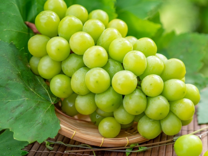 Green Grapes on a Round Bamboo Basket