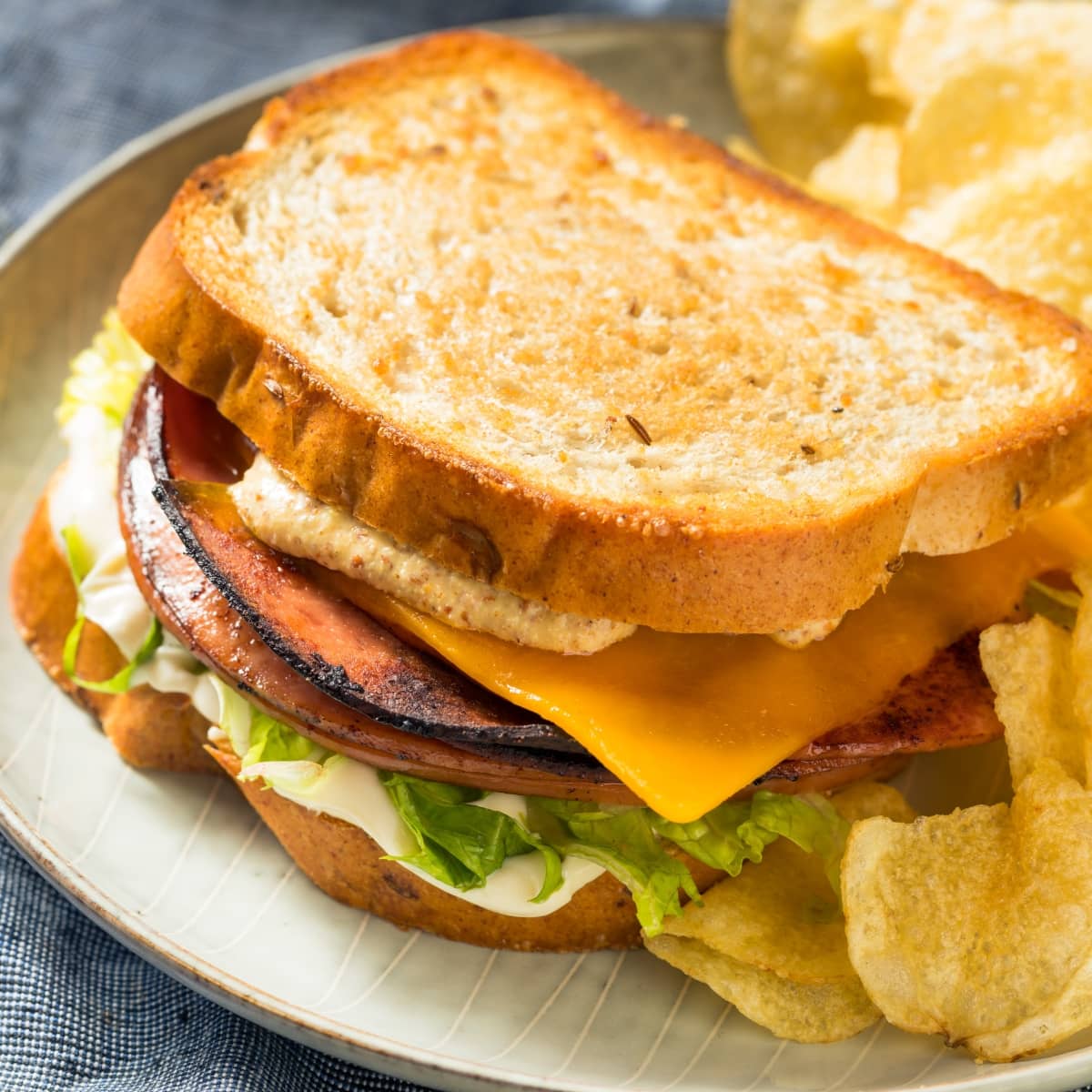 Homemade Fried Bologna Sandwich with Bread, Cheese and Chips