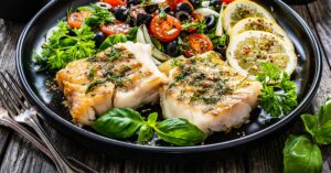 Homemade Grilled Cod Fish Fillet with Tomatoes, Olives and Lemons