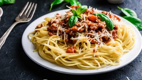 Homemade Pasta Bolognese with Ground Beef and Tomato Paste in a White Plate