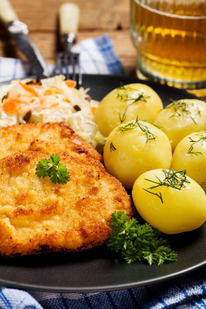 Oven-Fried Pork Chops Served With Coleslaw and Boiled Potatoes
