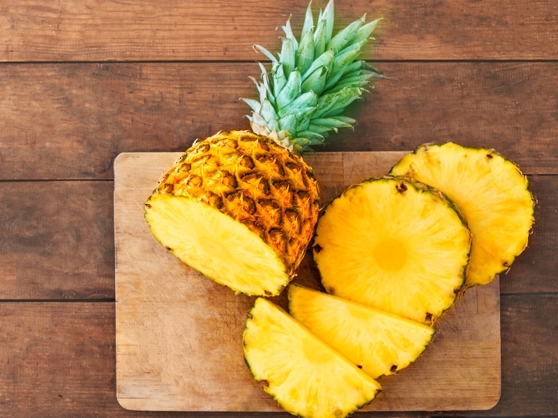Sliced Ripe Pineapple on a Wooden Chopping Board
