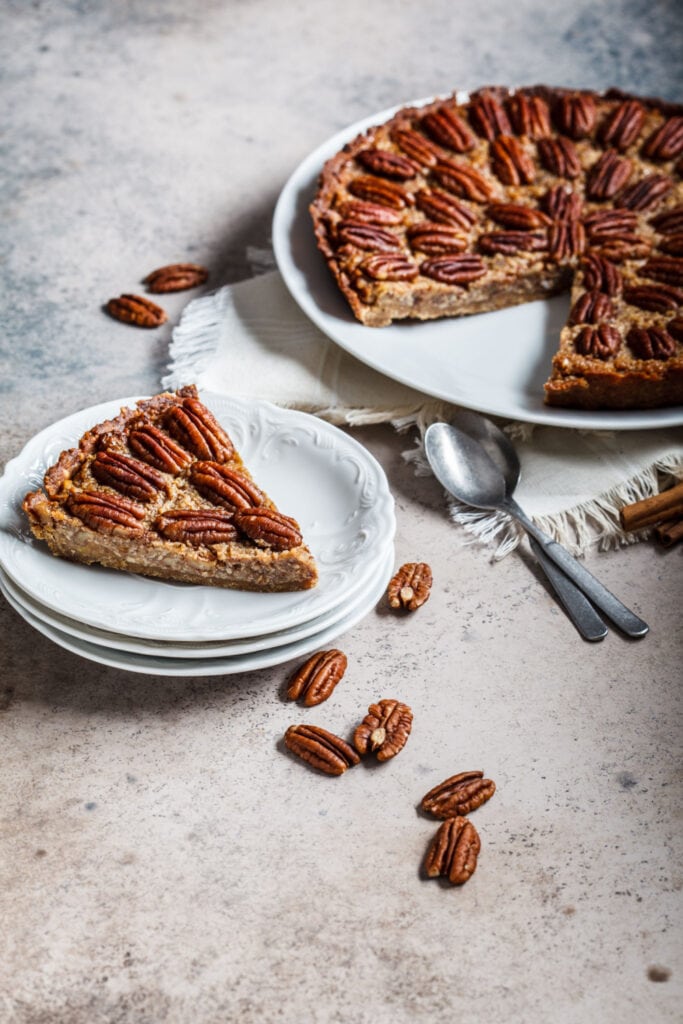 A slice of Pecan Pie on grey surface