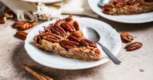 Sliced Homemade Pecan Pie in a White Plate