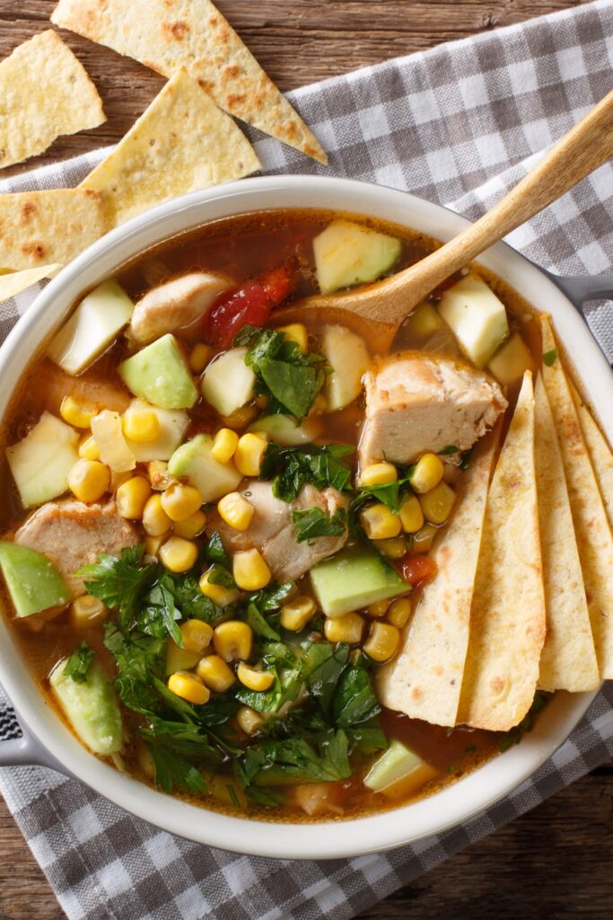 Spicy Chicken Chili Soup with Corn, Avocado and Tortillas