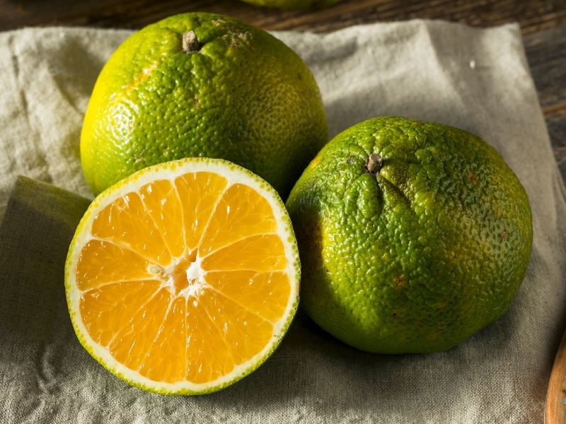 Ugli Fruit on a Cloth on a Wooden Table